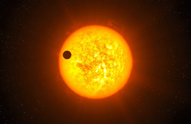Een exoplaneet die voor zijn ster langs trekt. (c) ESO/L. Calçada