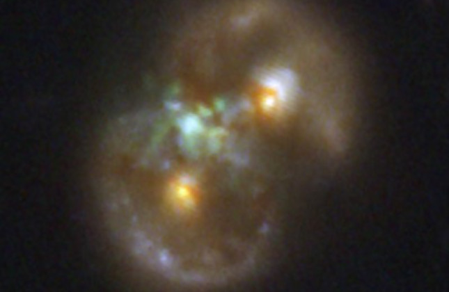 Het Oneindigheidsstelsel. In dit sterrenstelsel hebben astronomen een zwart gat van een miljoen zonsmassa’s ontdekt dat mogelijk is ontstaan door de ineenstorting van een gaswolk. © NASA, ESA, CSA, STScI, P. van Dokkum (Yale University)