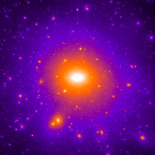 Afbeelding van een donkere-materiesimulatie van een galactisch systeem. Het beeld toont een centraal object dat omgeven is door duizenden satellieten, maar slechts enkele lijken op de satellietstelsels die de Melkweg omgeven en bevatten sterren (Credit: F